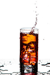 Splash Photography. Water Droplets With Ice Cubes Falling to Goblet. Against White Background.
