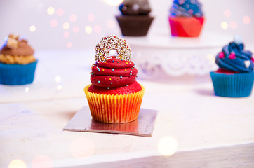 Beautiful decorated cupcakes with blurred lights in background and foreground 