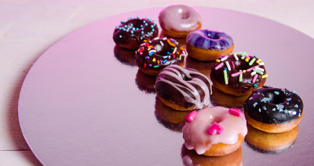 Beautifully decorated mini donuts with sprinkles and frosting 