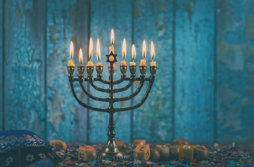 Closeup of a burning Chanukah candlestick with candles Menorah - obrazy, fototapety, plakaty