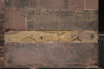 Stone carvings showing the standard sizes for bread sold in the open air market in Freiburg, Germany.