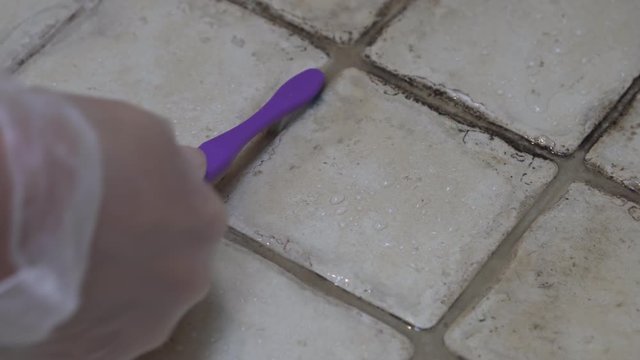 Close Up Scrubbing Dirty Moldy Tiles