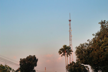 Fototapeta premium Several radio towers with blue sky in background