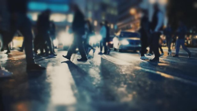 Shoppers and pedestrians cross the busy city intersection on a December night.