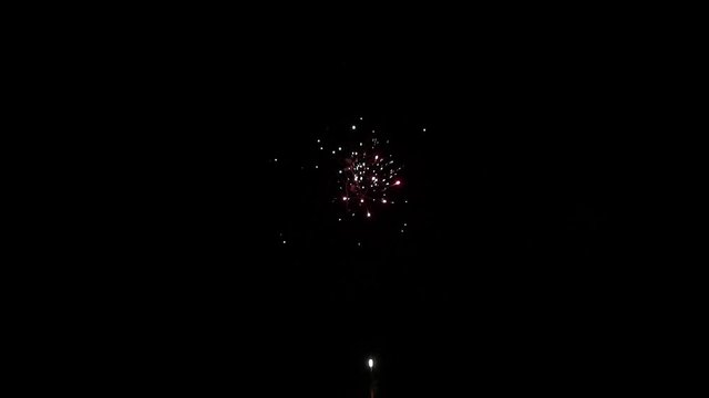 Explosion of bright colorful part of fireworks on black background to create a set salute on video for holiday new year, birthday, wedding or other celebration.