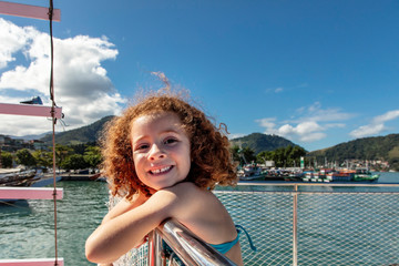 Redhead girl smiling on boat trip on Paradise Island in big island, Angra dos Reis Bay, Beach trip...