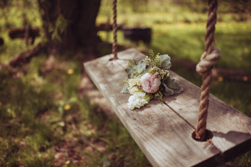 flower bouquet on a wood swing