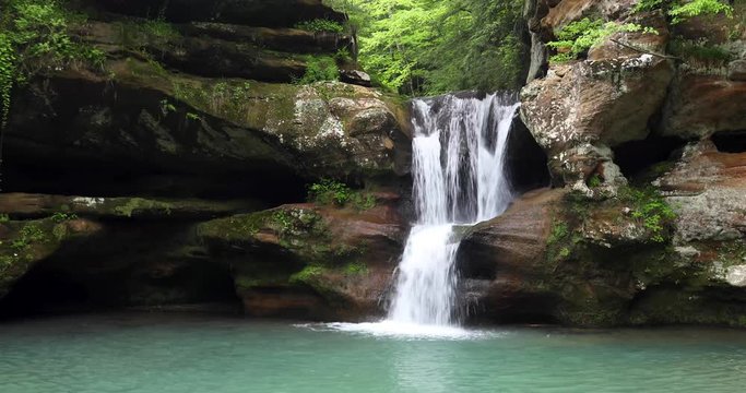 The beautiful Upper Falls at Old Man&rsquo;s Cave is a waterfall that cascades over a sandstone cliff in Hocking Hills State Park in Ohio. Looping video.
