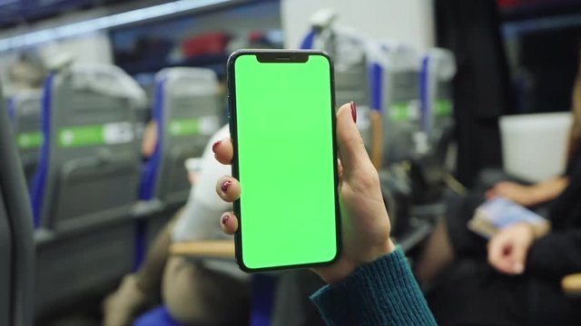 Hands woman hold use green screen phone sitting in bus touch telephone public communication vertical smartphone adult finger chroma urban cellphone application digital scrolling slow motion
