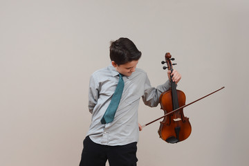 Boy playing viola wearing shirt and tie