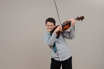 Boy playing viola wearing shirt and tie
