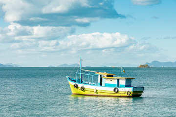 Fototapeta premium Boat in tropical big island (Ilha Grande), sea of Angra dos Reis bay with beautiful large mountains in the background, beach holidays on the coast of Rio de Janeiro, Brazil