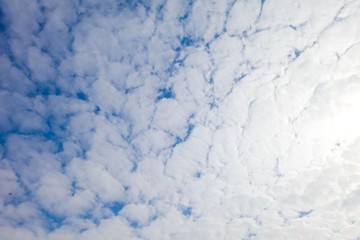 Beautiful fluffy white clouds or Altocumulus with blue sky and Sunlight, Nature background.