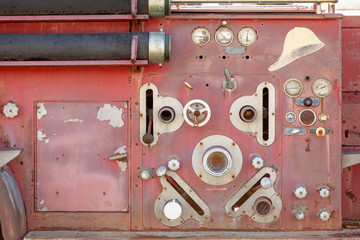 An old decommissioned fire truck lies rotting with pealing paint