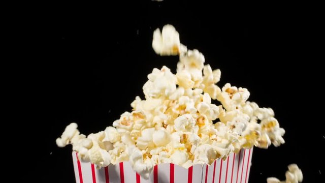 Popcorn falling in slow motion into a popcorn bucket