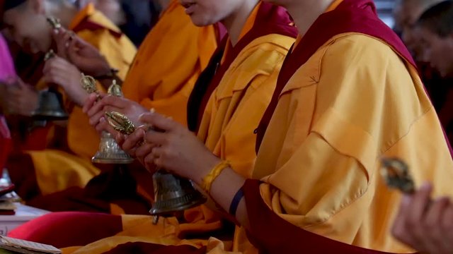 nuns holding the vajra and bell in their hand 