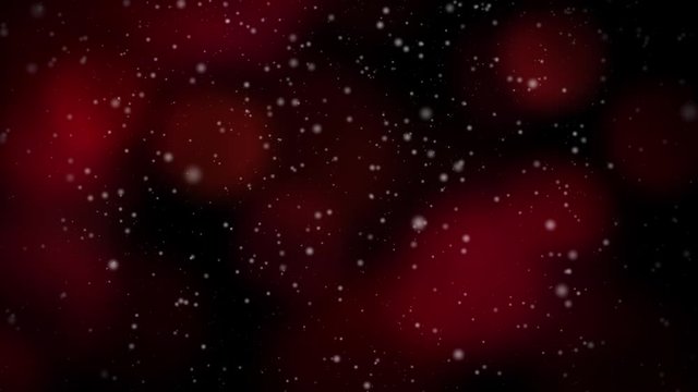 Abstract Seamlessly Looping Video features snow falling backed by colorful red blinking Christmas lights in the soft-focus background.