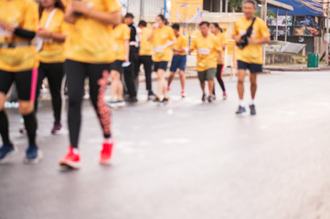 Obraz premium Out of focus and blurry background of marathon running race at the city road in the morning time.Family outdoor exercise for healthy.