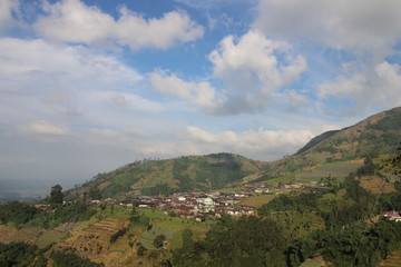 agriculture on the slopes of the mountains under the blue sky