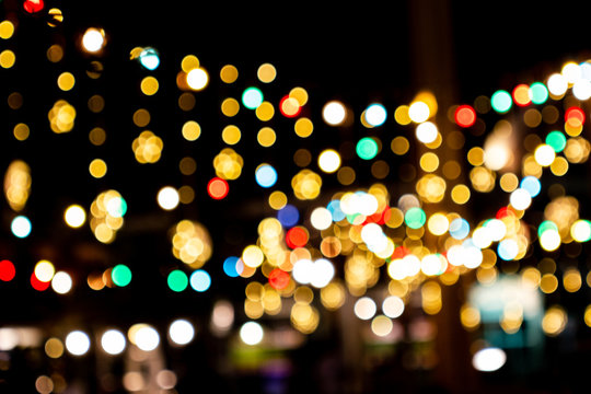 Blurred image Decorative outdoor string lights hanging in the garden at night time festivals season