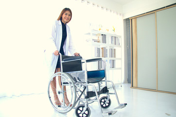 Female doctor standing behind a wheelchair