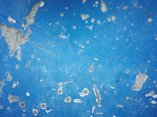 the old blue cement floor is full of holes and scratches