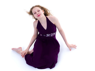 Naklejka premium Teen girl posing on the floor in the studio. The concept of styl