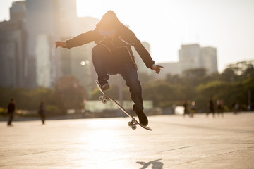Skateboarder skateboarding at sunset city