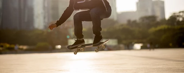Gordijnen Skateboarder skateboarding at sunset city © lzf