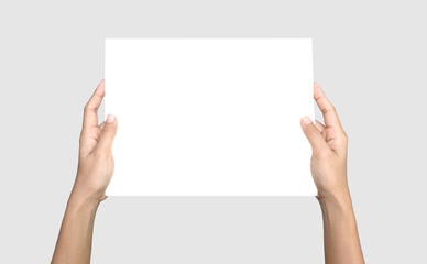 Female hands holding paper on a soft gray background. empty white sheet of paper, Clipping path