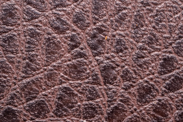 Fototapeta na wymiar Brown leather fabric close up macro background.