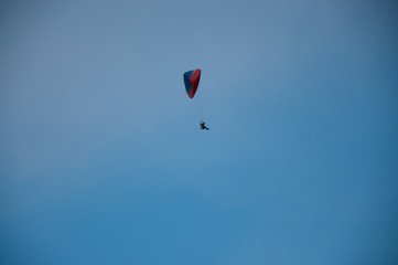 Lonely paraglider in the blue sky. Active rest in summer.
