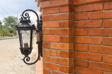 Antique electronic lamp, hanging at the  wall in the building,soft focus.