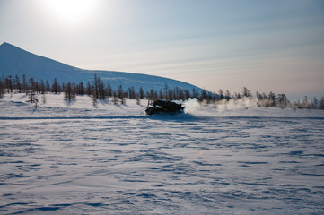Tracked all-terrain vehicle in winter ladscape in Kamchatka