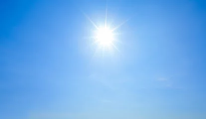 Gordijnen Shining sun with rays and clear blue sky © jamesteohart