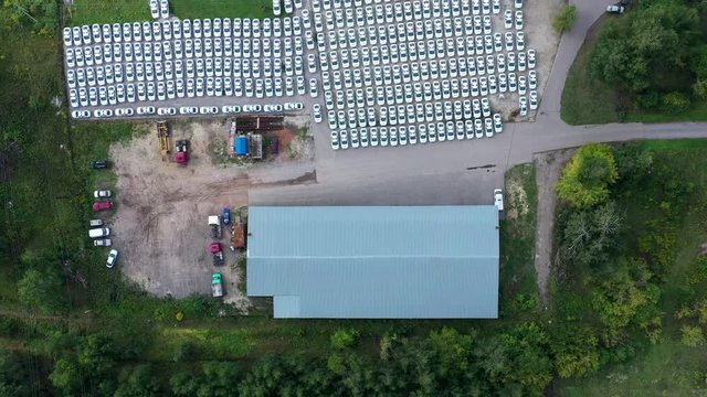Aerial top view from drone traffic police cars standing on countryside parking lot. Identical police patrol cars in parking lot in police department in suburban area