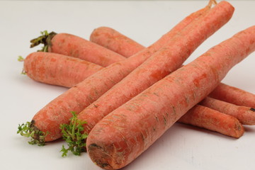 A stack of orange Carrots on a wooden background