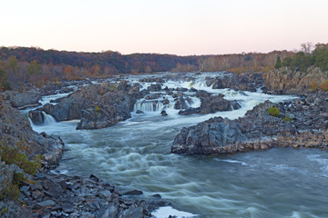 Potomac River waterfalls panorama in Great Falls state park in Virginia, USA. Great Falls state park at sunset in autumn with rocky riverbanks.