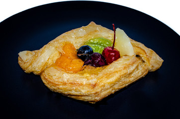 Fruit pastry in black plate