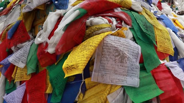 tibetan prayer flags tied up on a high passes on way to ladakh