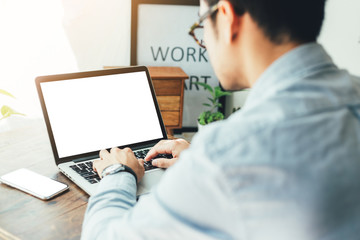 mockup image blank screen computer,cell phone with white background for advertising text,hand man using laptop texting mobile contact business search information on desk in office.marketing and design