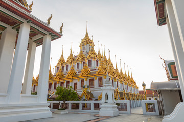 Fototapeta premium Loha Prasat, The metallic castle covered with gold leaf of Wat Ratchanadda Temple in Bangkok, Thailand.