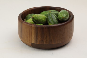 Parval or Pointed gourd in a wooden contianer.