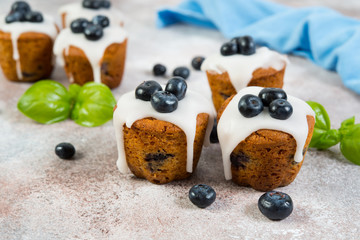 Delicious vanilla muffins in sugar Fudge lie on a concrete background. Horizontal photo.