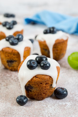 Delicious vanilla muffins in sugar Fudge lie on a concrete background. Vertical  photo.
