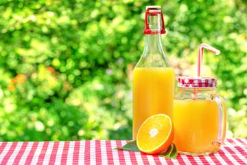 Glass jar and a bottle with orange juice