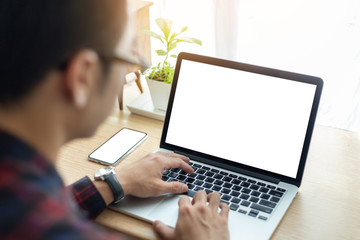 mockup image blank screen computer,cell phone with white background for advertising text,hand man using laptop texting mobile contact business search information on desk in office.marketing and design