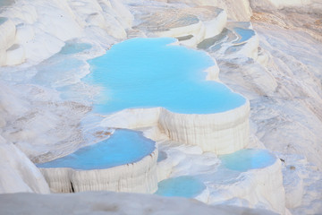 Travertine terraces with blue water in Pamukkale
