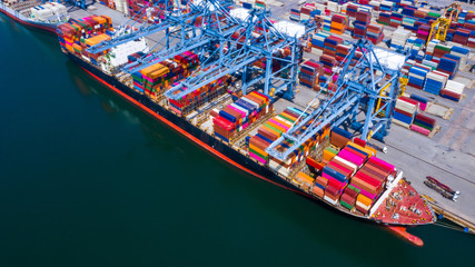 Aerial view container  ship at industrial port in import export business logistic and transportation of international by container ship in the open sea.
