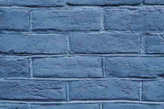 Cracked and textured blue wall, brick wall background. Color of the year 2020 concept. Close up. Fashionable classic blue color of spring-summer 2020 season from New York fashion week